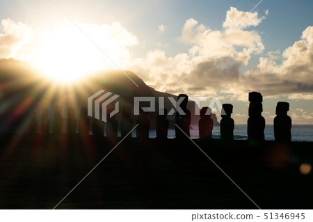 Bright sun rising behind Moai silhouettes in Easter Island 51346945