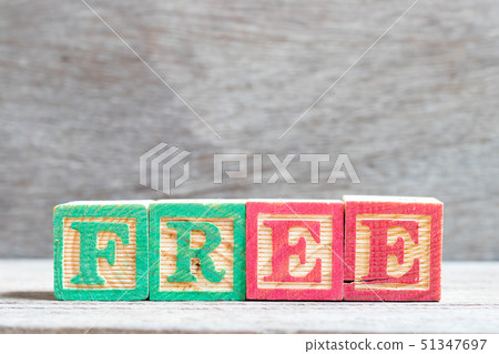 Color letter block in word free on wood background 51347697
