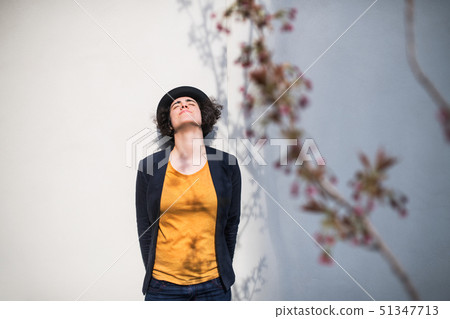 A young businesswoman standing outdoors, relaxing. Copy space. A young businesswoman standing outdoors, relaxing. Copy space. 51347713