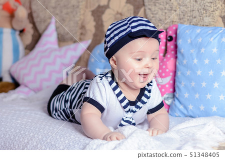 A sweet little child in a striped shirt and hats 51348405