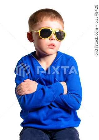 A boy in a blue jacket sits, isolated on a white A boy in a blue jacket sits, isolated on a white 51348429