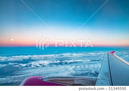 Sunrise view from the window of an airplane flying Sunrise view from the window of an airplane flying 51349500