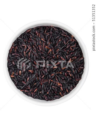 White bowl of raw organic black venus rice on 51351352
