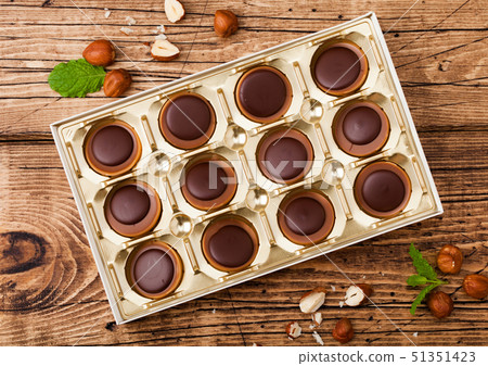 Box of homemade candies on wooden background  51351423