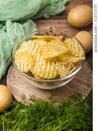 Homemade potato crisp chips inside glass bowl  51351575