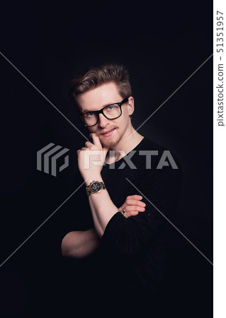 Portrait of young casual man with glasses in front of camera. Young handsome man in navy shirt and Portrait of young casual man with glasses in front of camera. Young handsome man in navy shirt and 51351957