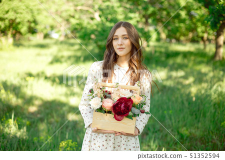 Half portrait of a charming positive woman dressed in long white summer dresses with a happy smile 51352594