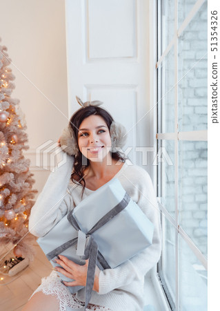 Young woman in an elegant dress near the Christmas tree 51354326