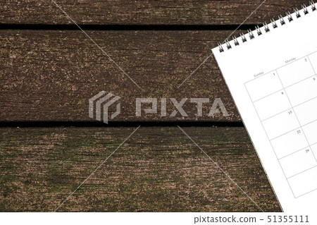 Calendar or planner on dark wood background Calendar or planner on dark wood background 51355111