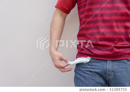 Man showing his empty pocket on wall background. Man showing his empty pocket on wall background. 51395733
