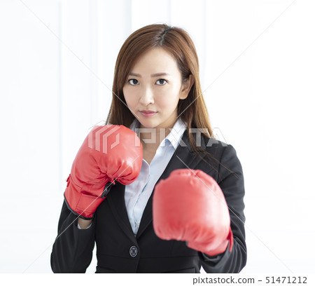 young Business woman wearing boxing gloves ready 51471212