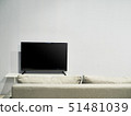 A television set with a beige colored sofa 51481039