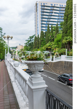 View of a high sidewalk with a fence with flowers View of a high sidewalk with a fence with flowers 51580001