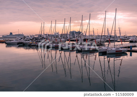 Pink sunset in the sea harbor with moored yachts. Pink sunset in the sea harbor with moored yachts. 51580009