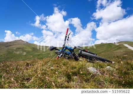 Downhill mountain bike lying on mountains Livigno Downhill mountain bike lying on mountains Livigno 51595622