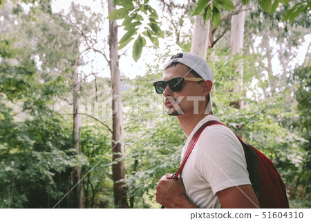 man with backpack walking in the forest man with backpack walking in the forest 51604310