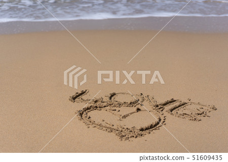 Heart and word love drawn on beach sand Heart and word love drawn on beach sand 51609435