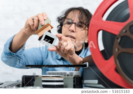 woman technician cleaning a vintage slide woman technician cleaning a vintage slide 51615183