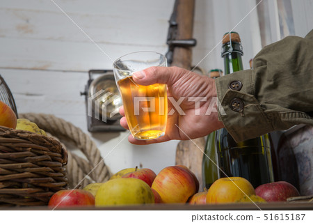 man drinking a glass of cider, bottle and organic 51615187