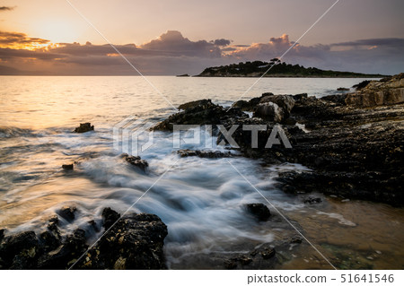 Sunset on the rocky shores of the Ionian Sea. Paxos, Greece. 51641546