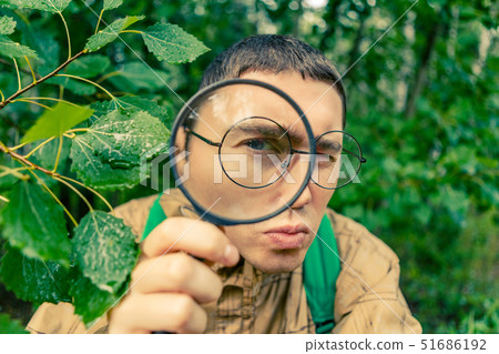 Portrait of male botanist with magnifying glass 51686192