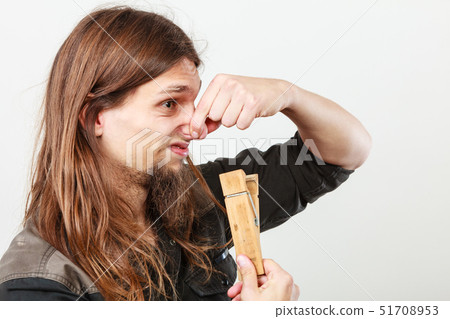 Man with clogged nose by clothespin 51708953