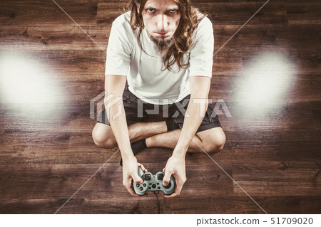 Unhappy male playing games 51709020