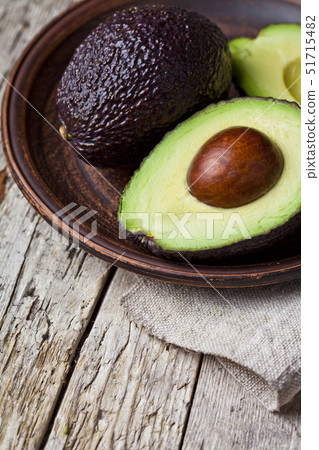Fresh organic avocado on ceramic plate and linen 51715482