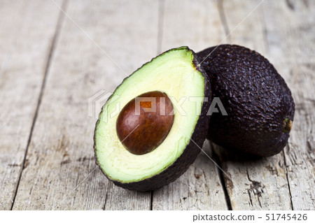 Fresh organic avocado halves on old wooden table 51745426