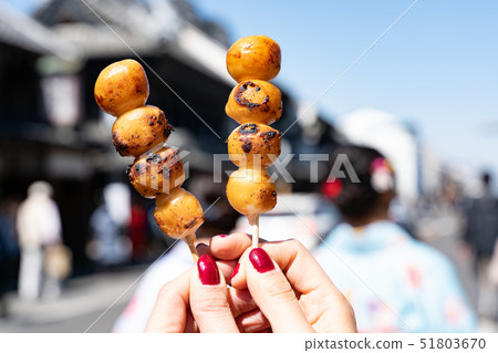 Eating grilled dumplings 51803670