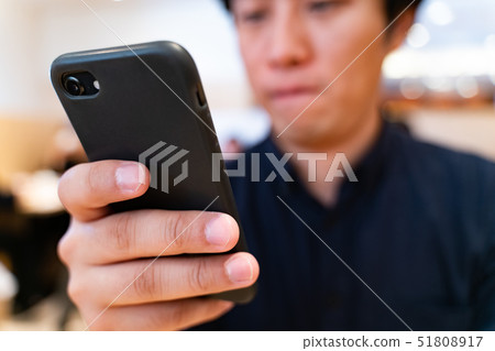 Holiday men checking smartphones Holiday men checking smartphones 51808917