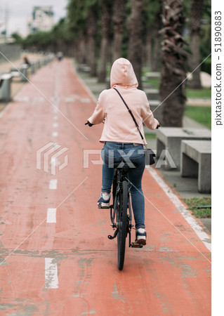 cyclist on a bike path on the embankment cyclist on a bike path on the embankment 51890883
