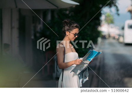 tourist woman looking at the map on the street 51900642