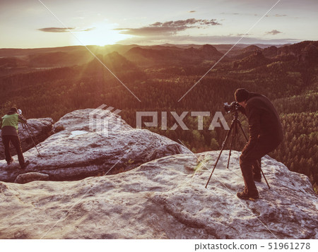 Photographer check display of camera on tripod. 51961278