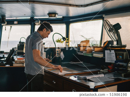 Marine navigational officer or chief mate on navigation watch Marine navigational officer or chief mate on navigation watch 51986198