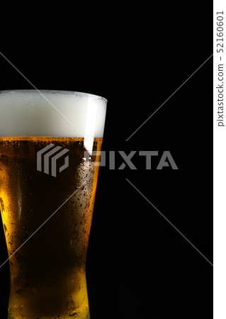 Image of draft beer poured into glass with water drops Image of draft beer poured into glass with water drops 52160601