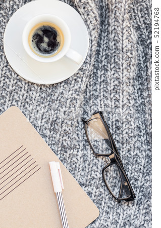 Home workplace with coffee cup on knitted plaid 52194768