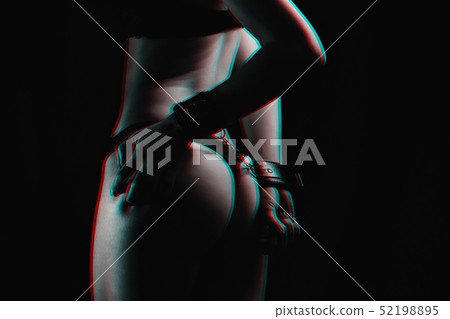 submissive girl with hands in handcuffs bites her nails into her sexy ass 52198895