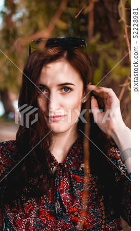 Beautiful young woman in burgundy leaves Beautiful young woman in burgundy leaves 52228981