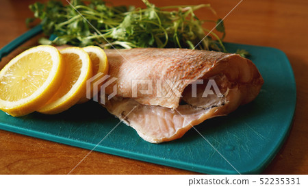 Fresh fish, raw cod fillets with addition of herbs and lemon Fresh fish, raw cod fillets with addition of herbs and lemon 52235331
