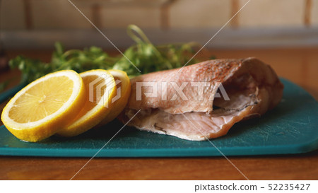 Fresh fish, raw cod fillets with addition of herbs and lemon Fresh fish, raw cod fillets with addition of herbs and lemon 52235427