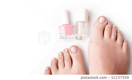 Young perfect groomed womans feet on white background. Care about nails Young perfect groomed womans feet on white background. Care about nails 52237509