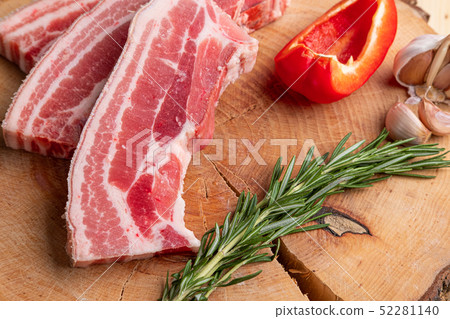 Raw fresh pork brisket slices on wooden board Raw fresh pork brisket slices on wooden board 52281140