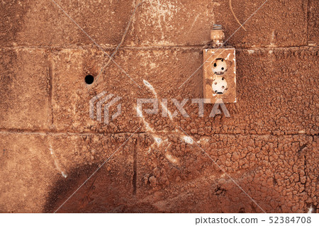 An electrical outlet on a stained wall An electrical outlet on a stained wall 52384708