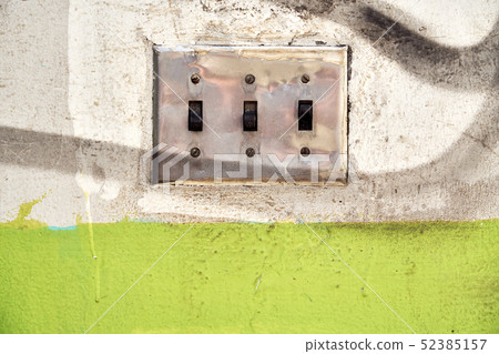 Electric switch on soiled wall 52385157