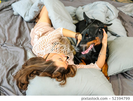 Woman in bed with big dog 52394799