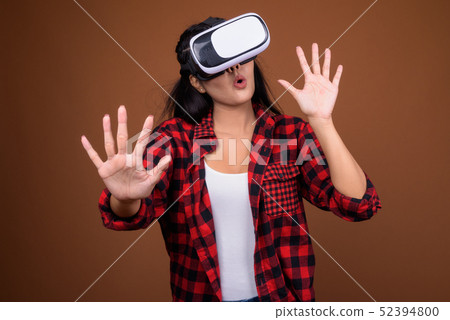 Happy Asian woman using VR glasses for virtual reality playing Happy Asian woman using VR glasses for virtual reality playing 52394800