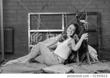 Woman in bed with big dog Woman in bed with big dog 52394818