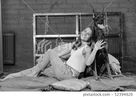 Woman in bed with big dog 52394820