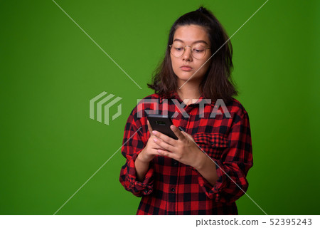 Young beautiful Asian hipster woman wearing eyeglasses and red checkered shirt 52395243